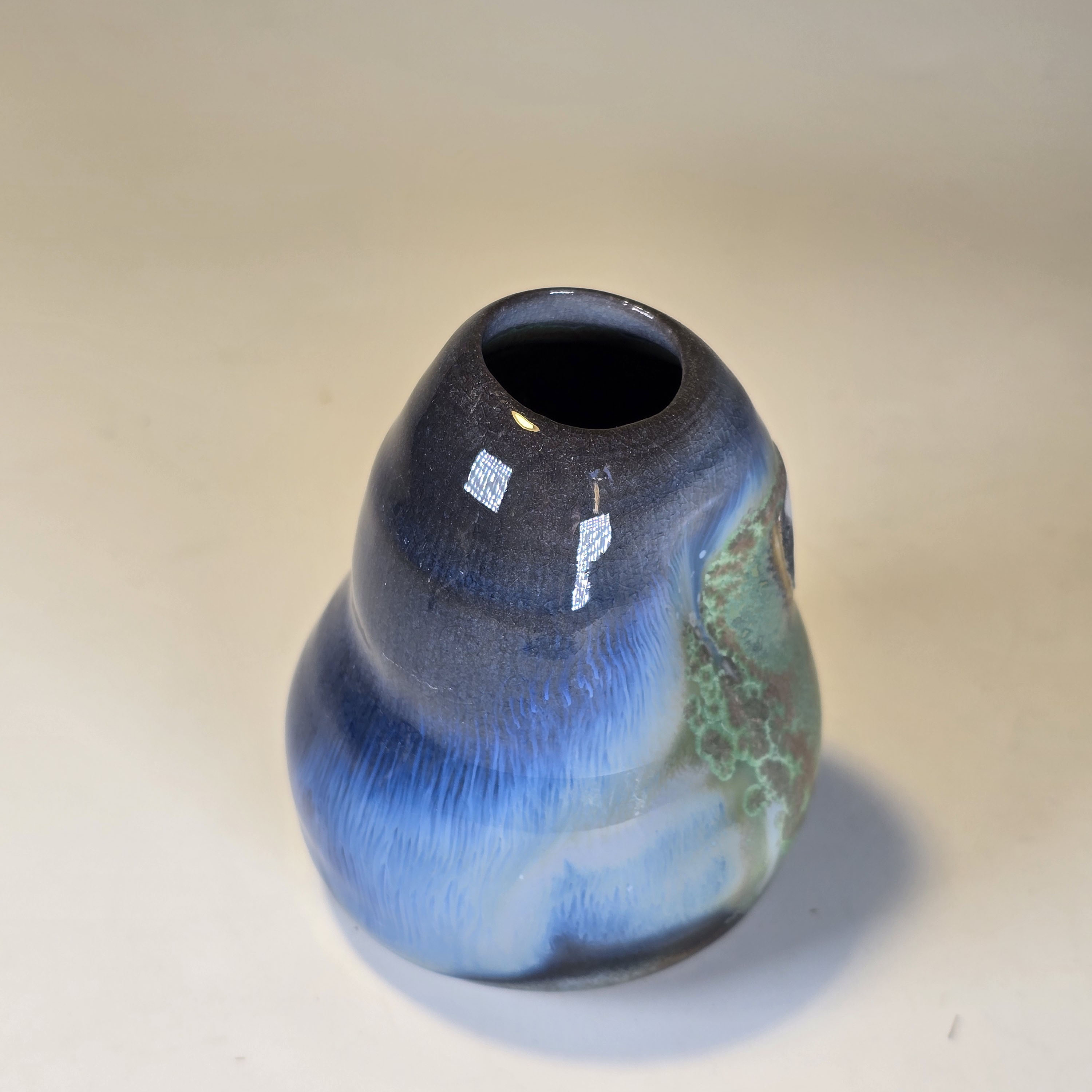Soda-fired ceramic bud vase shading from blue to gray