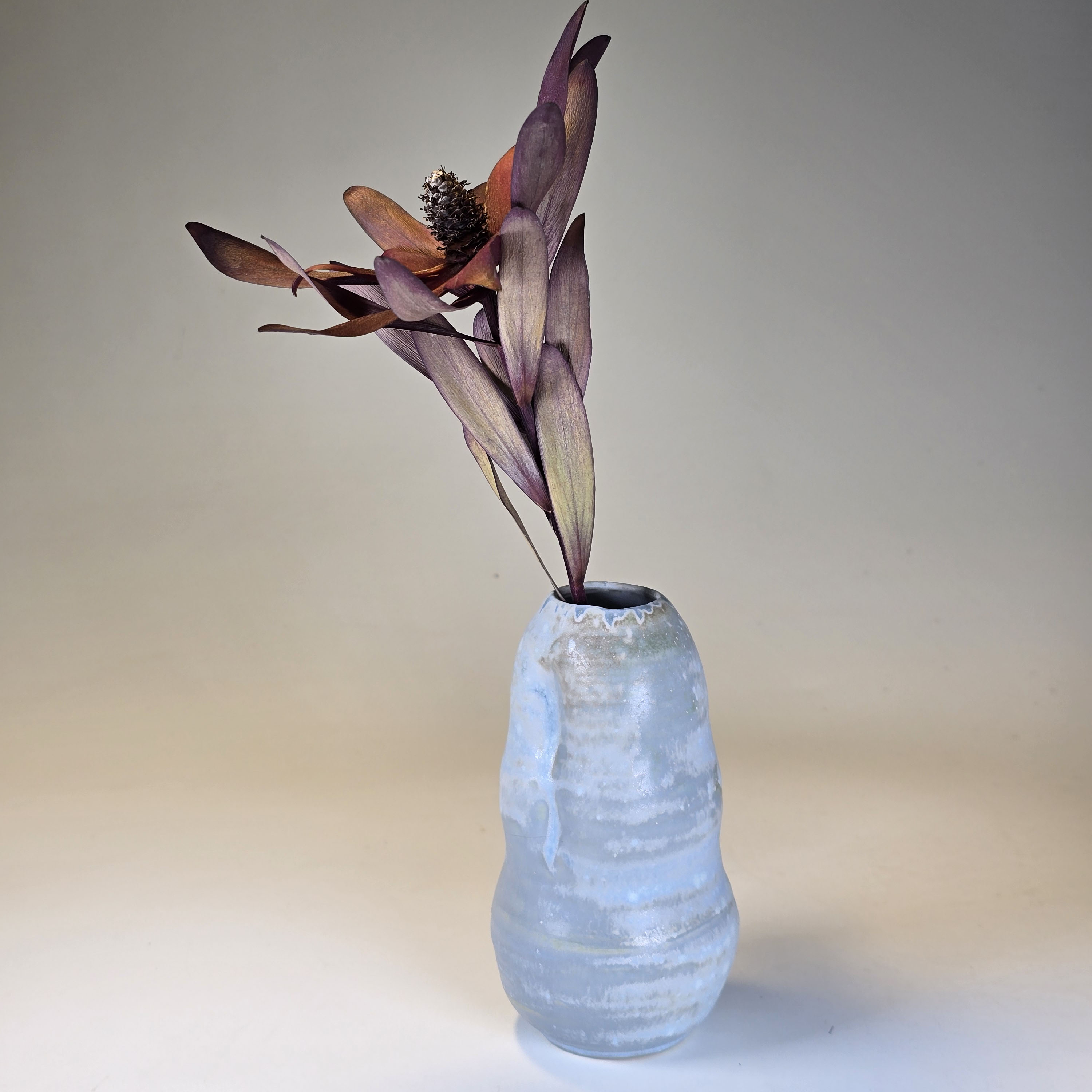 Soda-fired ceramic vase with a matte blue glaze