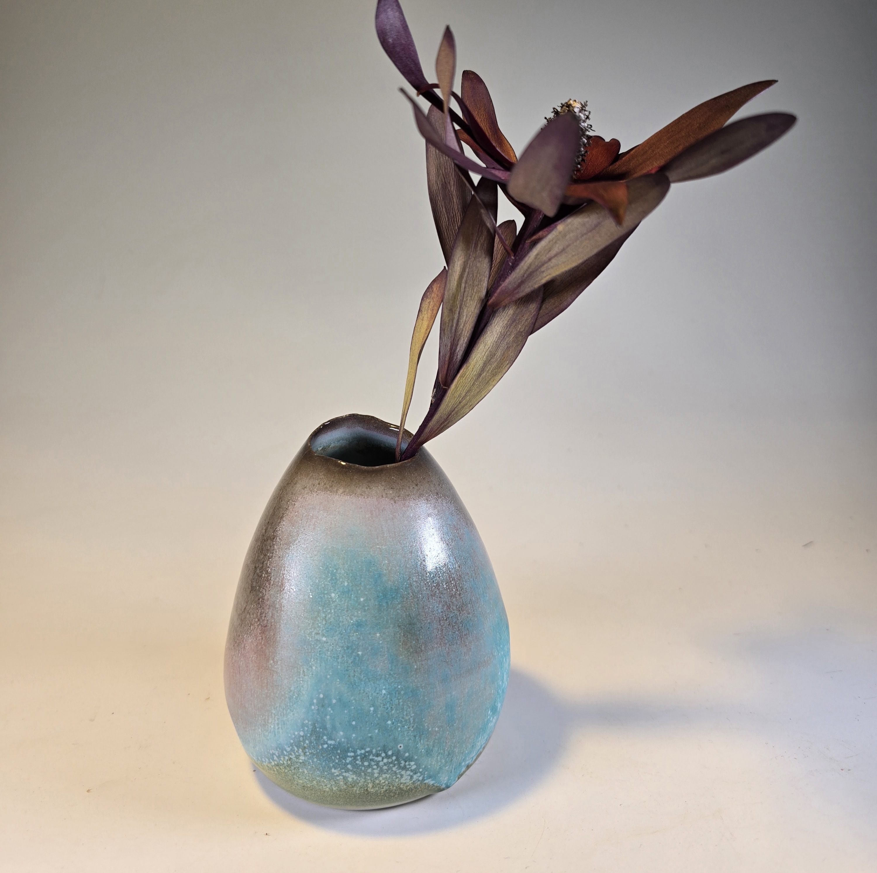 Soda-fired ceramic vase with a matte turquoise glaze