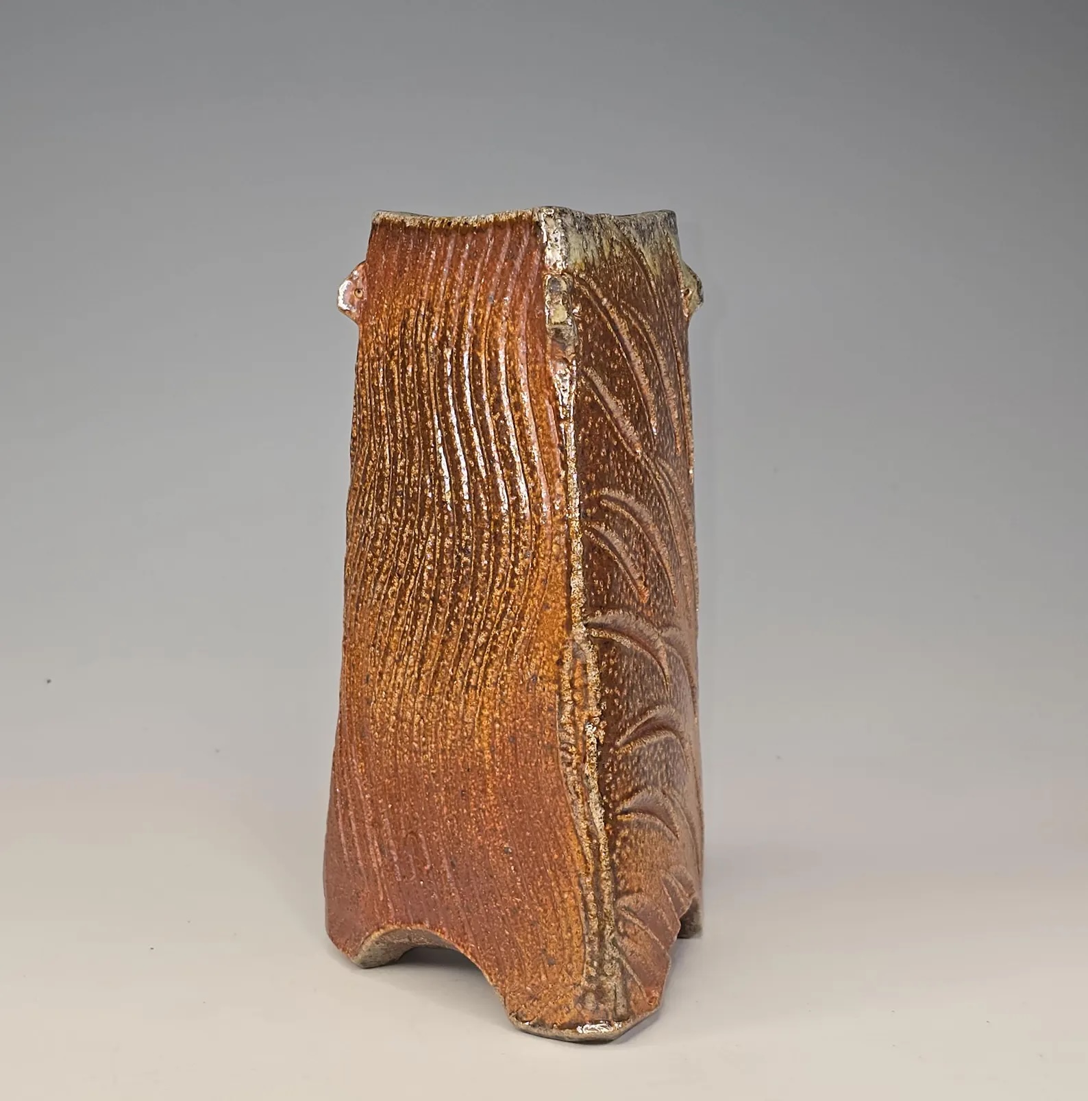 Soda-fired ceramic vase with slip decoration and black underglaze