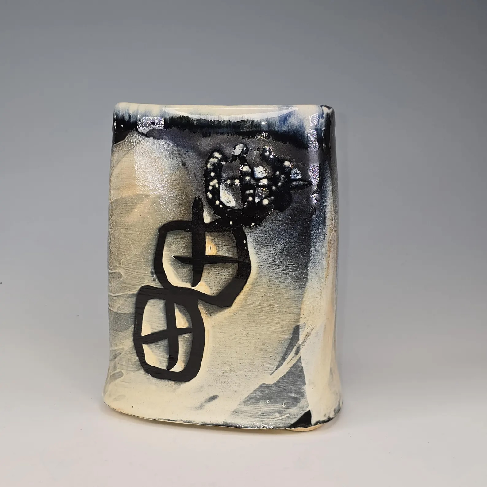 Soda-fired ceramic vase with slip decoration and black underglaze